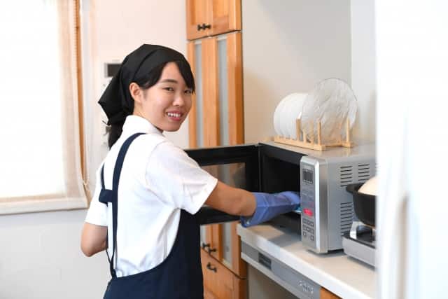 電子レンジを掃除する女性